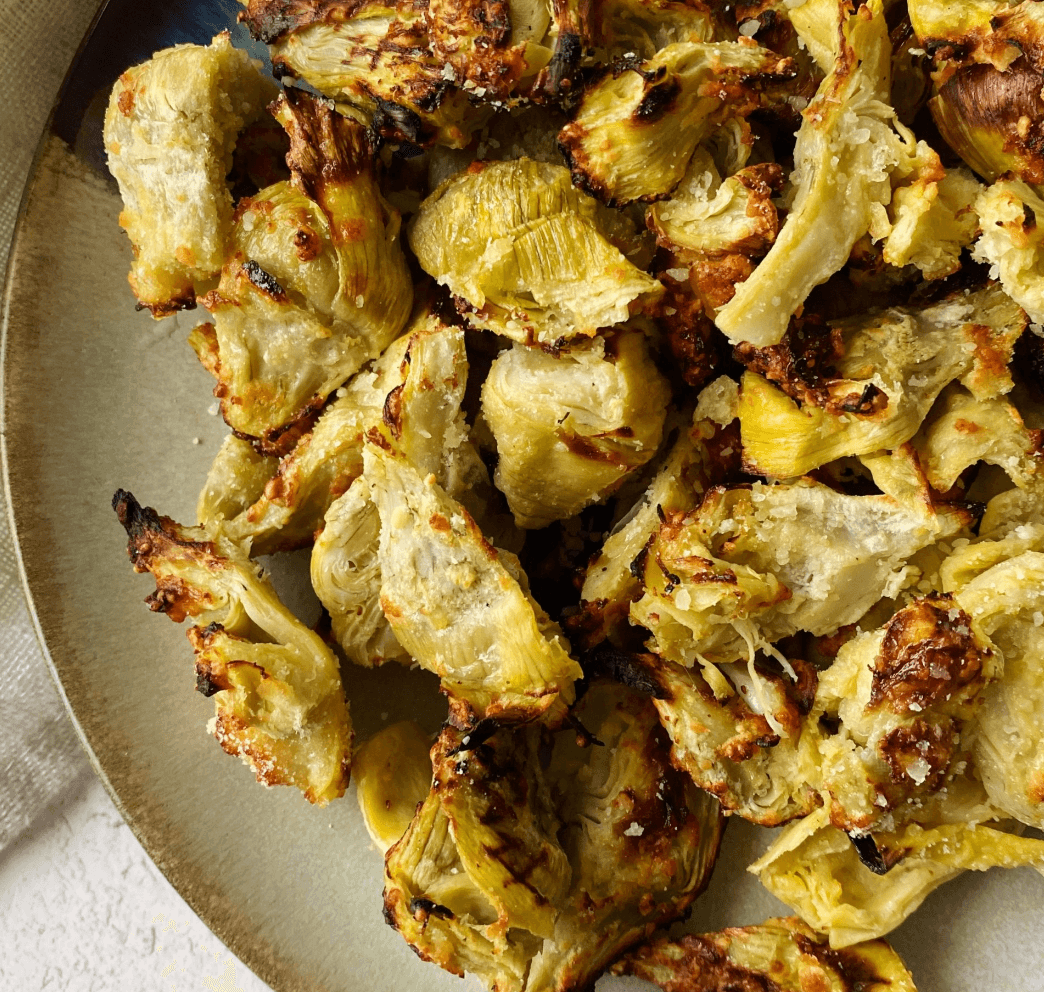 Crispy roasted artichoke hearts with salt, pepper, and olive oil, golden brown and perfect as a side dish.