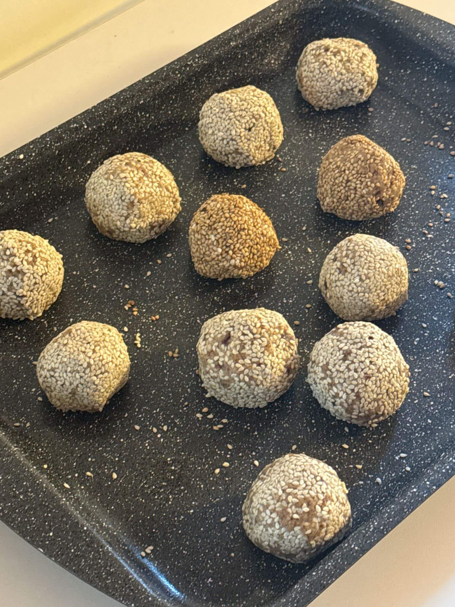 Vegan tahini date balls with dates, walnuts, and tahini, optionally coated in sesame seeds, a protein-packed snack.