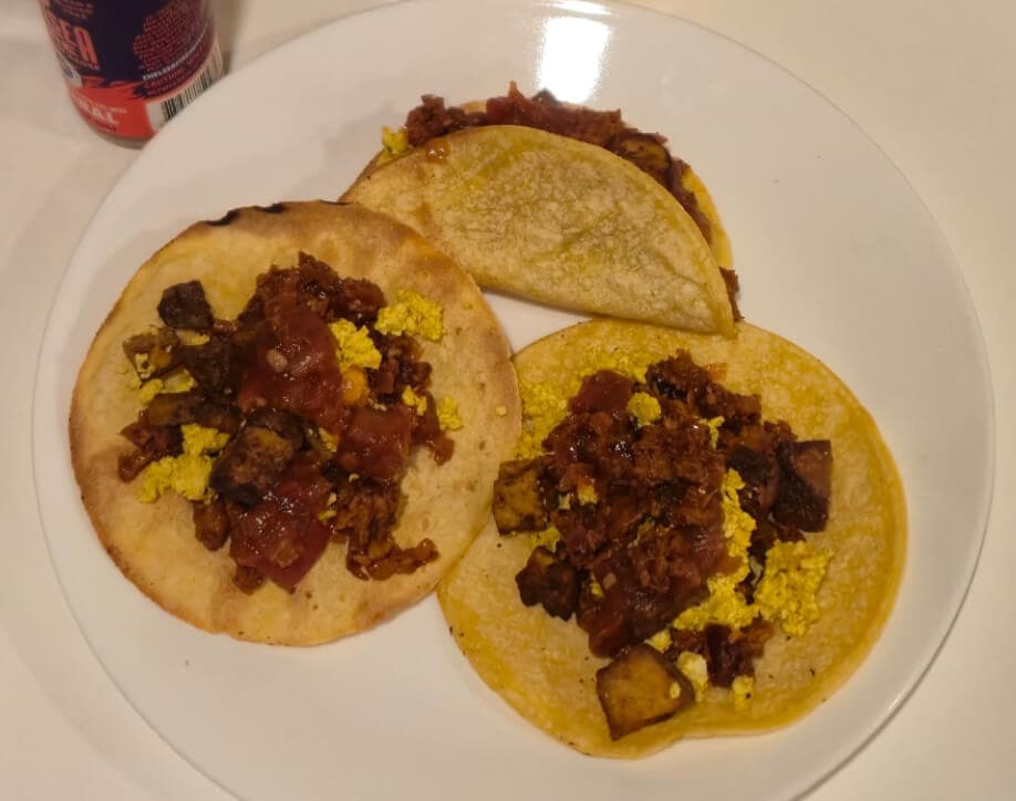 Vegan breakfast tacos with seasoned vegan meat, onions, garlic, adobo, and salsa. Ready in 30 minutes or less.