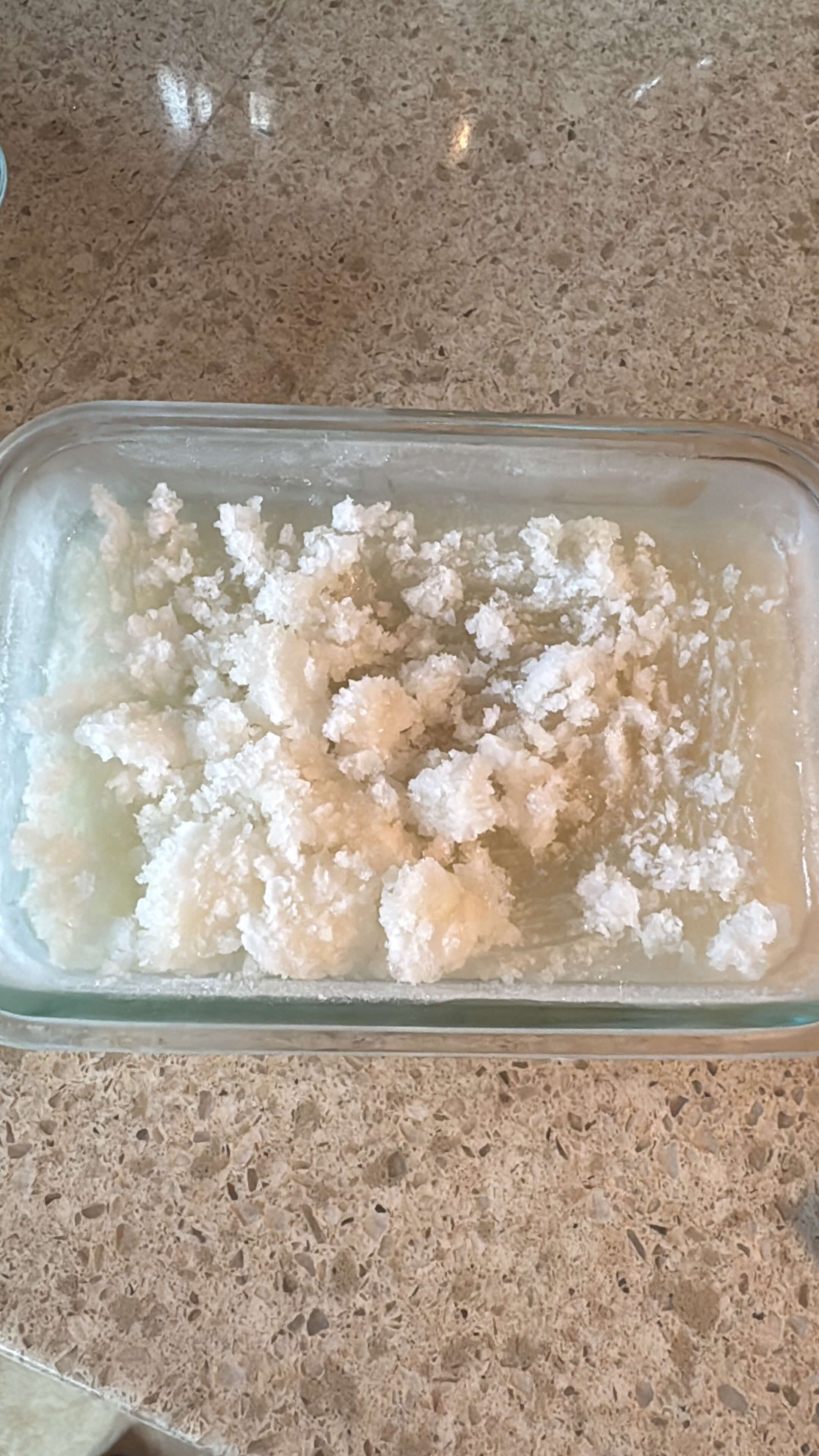 Vegan lemon peel granita with lemon zest, sugar, water, and optional orange liqueur, a sweet and tart icy dessert.