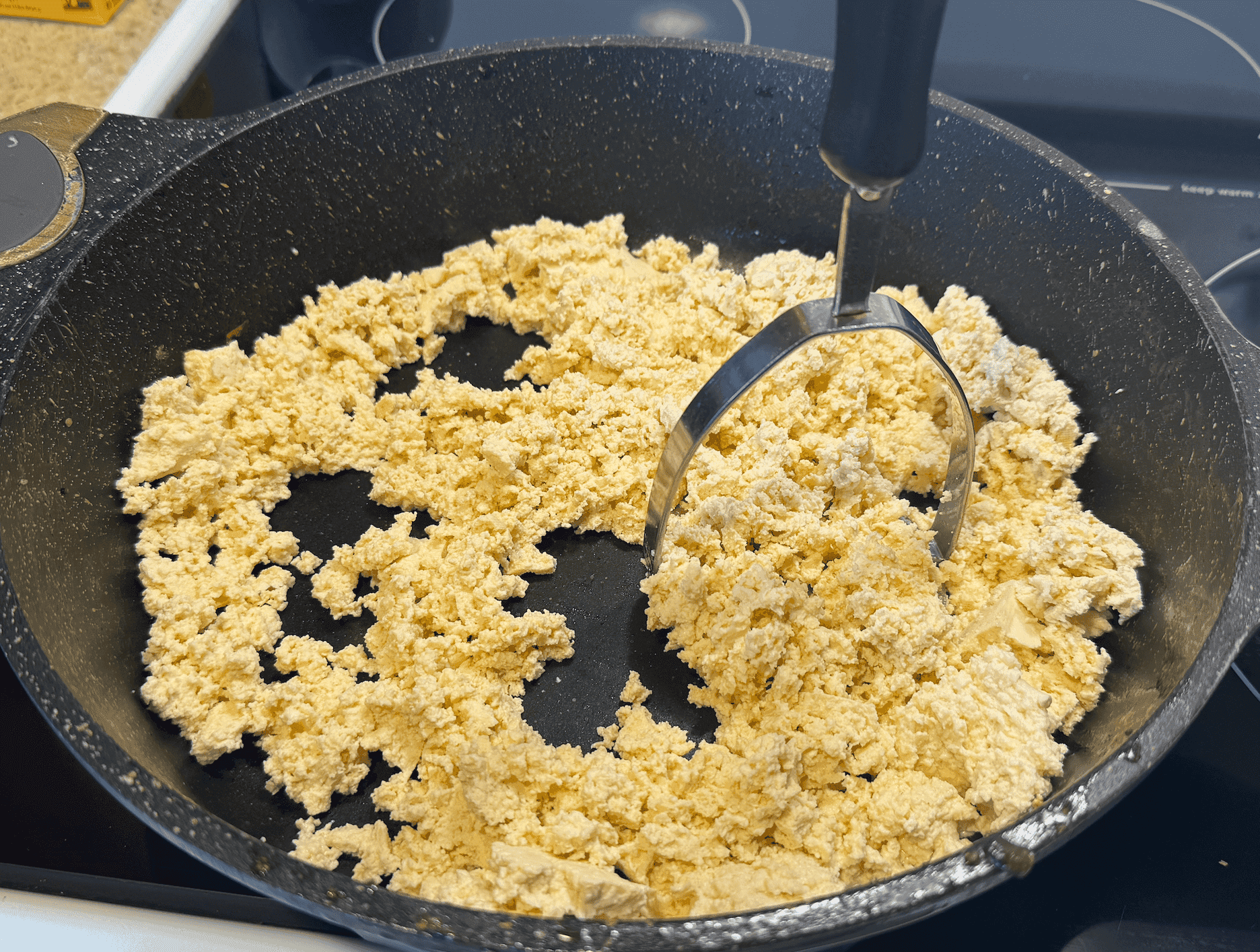 Press the tofu into small crumbles in the pan